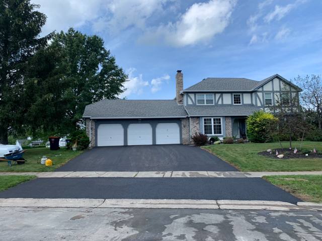 New driveway and apron at a home with a three-car garage