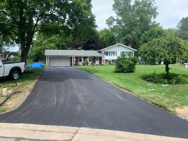 New asphalt driveway at a split-level home
