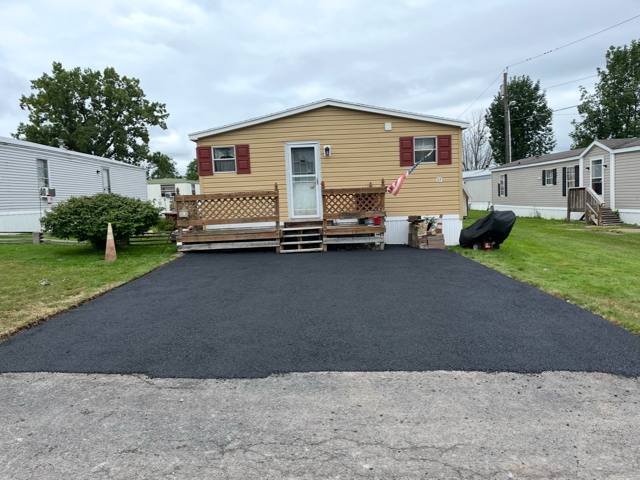 New driveway at a yellow manufactured home