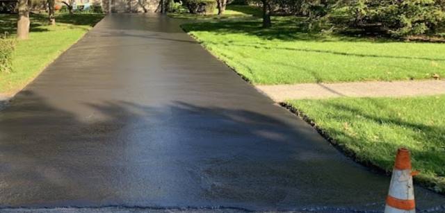 Glossy freshly sealcoated driveway