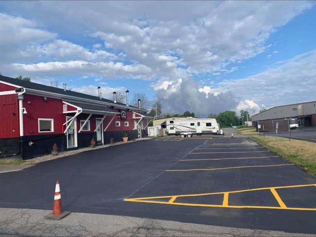 Freshly finished commercial parking lot beside a red building