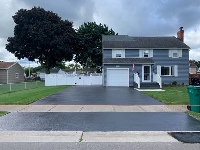 Sealcoated driveway and apron at a blue colonial