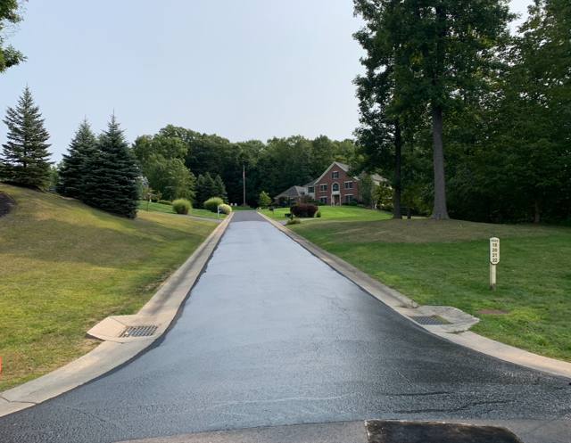 Long curbed private drive freshly sealcoated