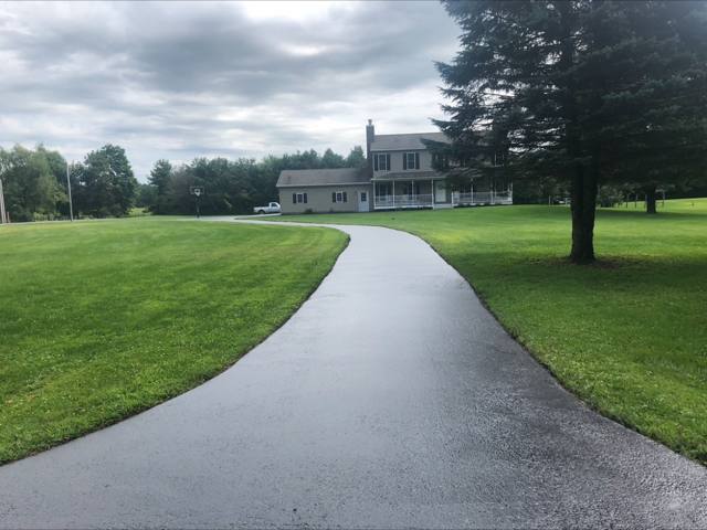 Sealcoated winding driveway across a wide lawn
